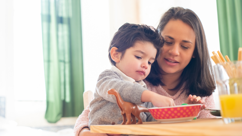 Criança come com a mãe. / Foto: Pexels